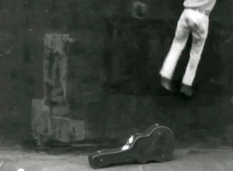 Bob Dylan climbing down off the small roof