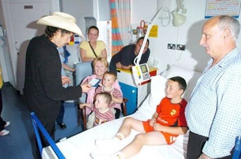  In 2004, in Northern Ireland, Bob made a surprise visit at the Royal Victoria Hospital. There, he played harmonica for children and signed autographs.