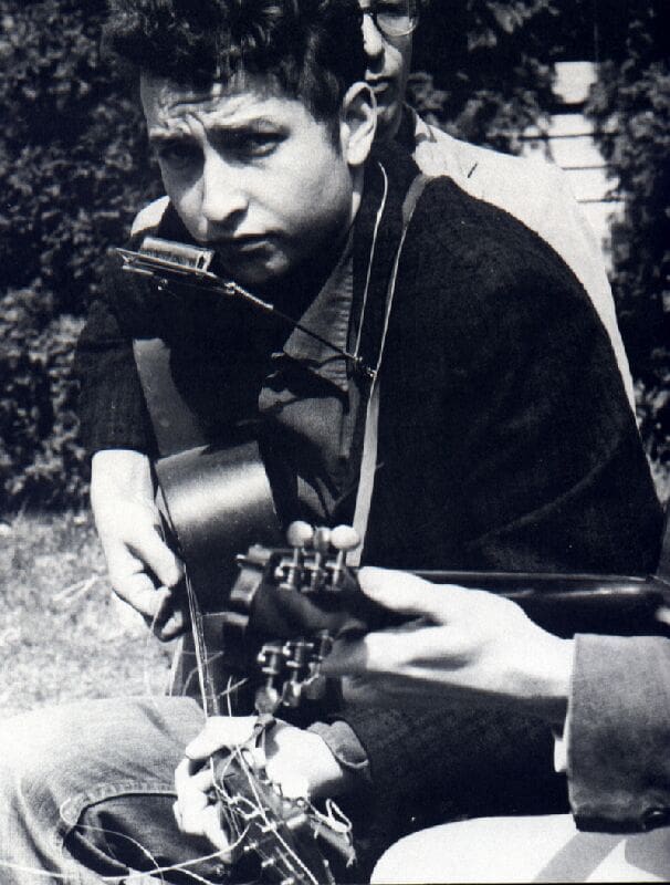 Bob Dylan sings with Mark Spoelstra, Indian Neck Folk Festival, May 6th, 1961.Bobby Neuwirth in the foreground with the shades