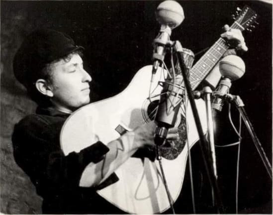 Bob Dylan performs at The Bitter End folk club in Greenwich Village in 1961. by Sig Goode