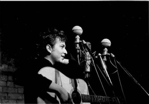 Bob Dylan performs at The Bitter End folk club in Greenwich Village in 1961. by Sig Goode