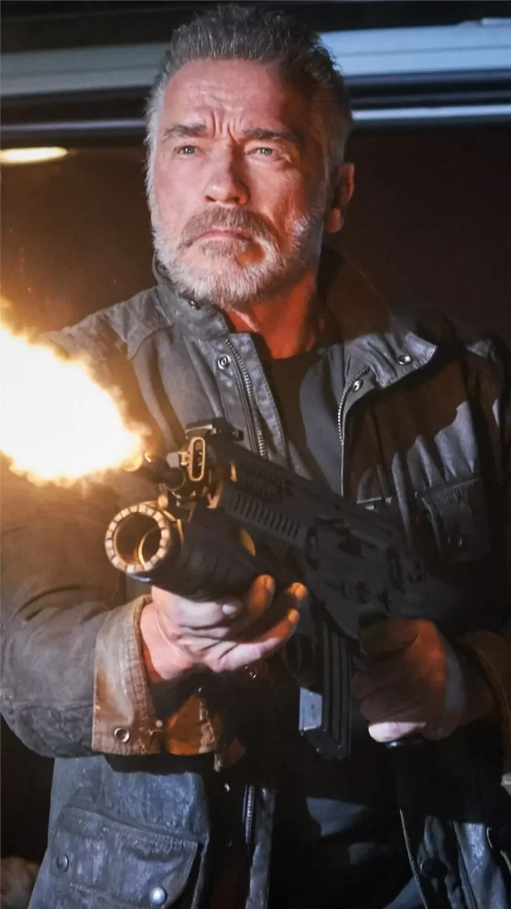 Arnold Schwarzenegger fires an automatic weapon