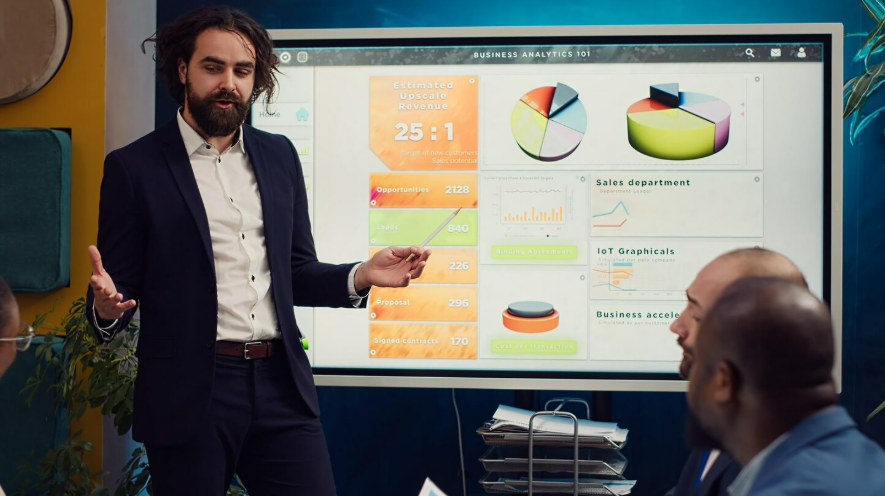 When Presentations Stop Being Boring and Start Being Fun 2 Team leader showing infographics data on interactive board